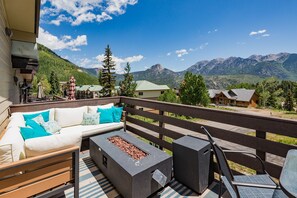 Huge deck with couch, gas fire pit, dining table and gas grill