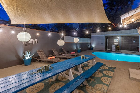 Amazing outdoor space, large dining table with beautiful night lighting as well