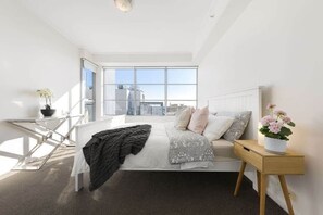 The master bedroom with a queen sized bed & plush pillows..