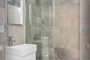 Recently renovated bathroom with stand-up shower.