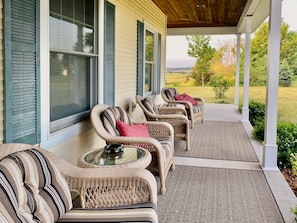 Farmhouse-style front porch facing the sunset