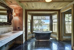 Primary bath with tub and Aesop amenities