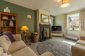 1 Riverside Cottages, Burnsall: Sitting room with wood burning stove and a lovely view