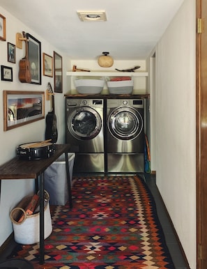 Laundry easily accessible in the main hallway.