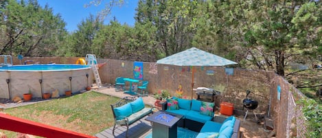 View from the deck looking down at the outdoor seating and pool area