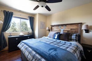 Master bedroom with KING size bed, smart tv, reading lights, and charging stations