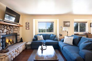 Open floor plan: fireplace, smart TV, and comfy seating while connected to those in the kitchen