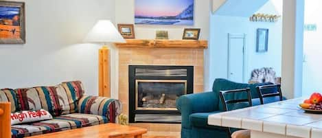 Cozy living room with fireplace and TV.