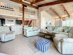 Living area with view of the loft and kitchen.