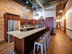 Granite countertops, stove, microwave, dishwasher, refrigerator , freezer with ice maker, all the dishes, pots, pans, barware and more thats needed for kitchen. 