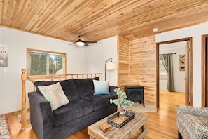Upstairs living room with wood burning fireplace.