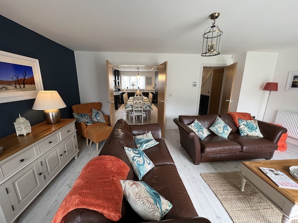 Stunning lounge with doors leading to dining for 8/9 people & fab navy kitchen