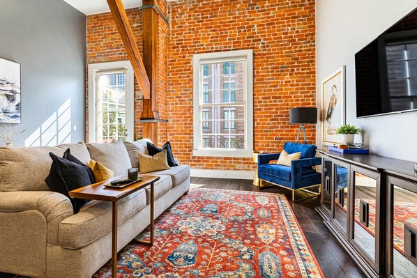 Open concept living, kitchen, and dining with plenty of seating. 65” Samsung Smart 4K TV for streaming and DIRECTV. Sofa converts to a queen-size sleeper. Dining table seats four. Enjoy lots of natural light!