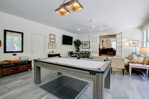 Game room with a pingpong/pool table, board games, & a poker table + more