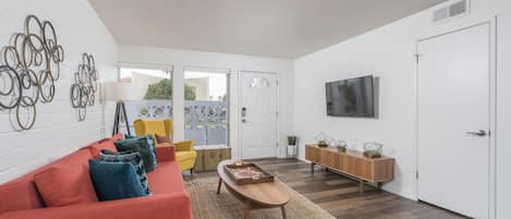 Another view of the living room with a glimpse outside from the large picture windows.