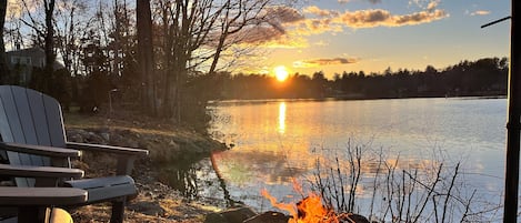 Sunset and camp fire by the water