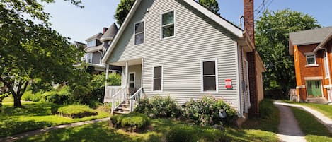 Front of house; Your entrance located down shared driveway & to the left.