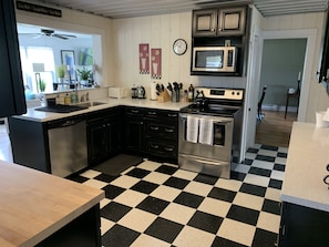 Well-stocked kitchen open to breakfast area and living room