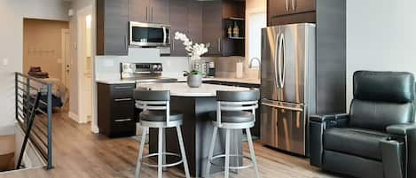 Kitchen with granite counters and Keurig® coffee maker.