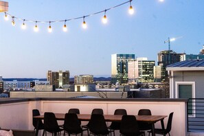 Enjoy a private rooftop deck with outdoor dining, comfortable seating and movie projector