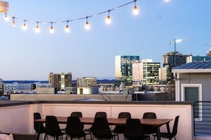 Enjoy a private rooftop deck with outdoor dining, comfortable seating and movie projector