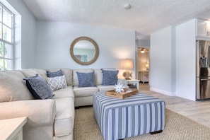 Naturally lit entrance and first open- spaced living room/ kitchen.