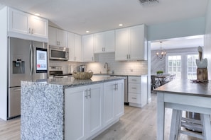 Open plan upgraded kitchen with marble counter tops, stainless steel appliances & Smart Fridge!