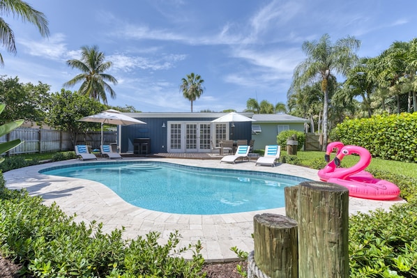 Relaxing family friendly 3-bedroom & 2-bathroom Villa situated between Palm Beach and Jupiter features a large, tropical, outdoor entertainment space with large pool, BBQ Gas Grill, patio dining and lounging and Cornhole