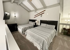 Upstairs lofted bedroom w/ 2 queen beds and ensuite bathroom