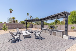 Backyard Resort featuring a sparkling blue oasis and spa, BBQ grill, Covered Patio w/ Outdoor Dining, fire pit and a Sports Court!