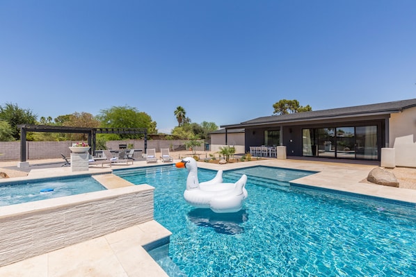 Backyard Resort featuring a sparkling blue oasis and spa, BBQ grill, Covered Patio w/ Outdoor Dining, fire pit and a Sports Court!