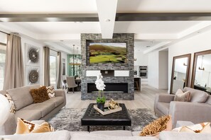 Bright Contemporary Living Room featuring a flat-screen SMART TV and designer furnishings.