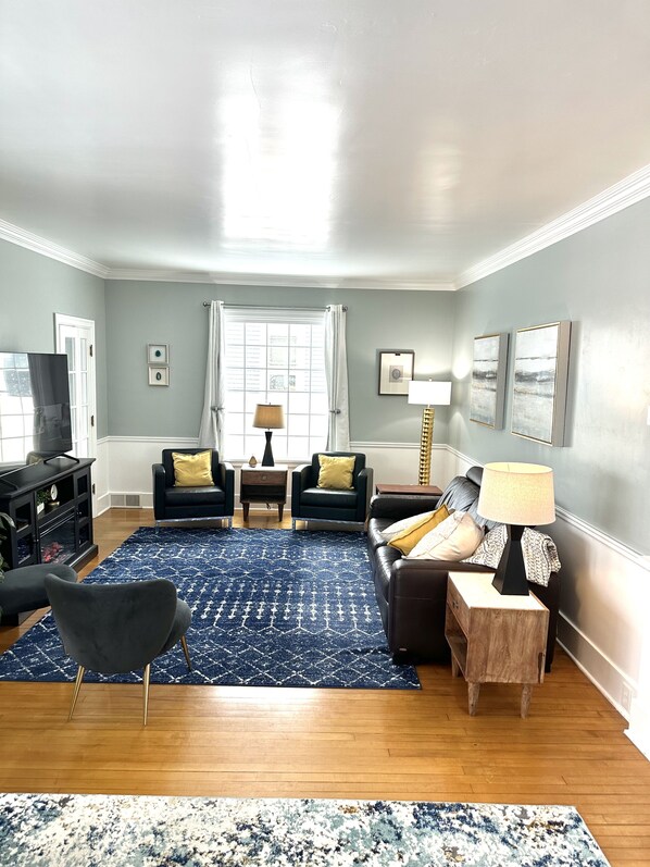 Tv room with fireplace and recliner sofa.