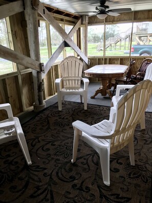 Huge screened in porch with table and pull out sofa - and three ceiling fans.