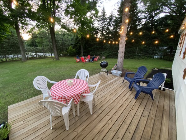 Front deck with seating and a Weber charcoal smoke grill