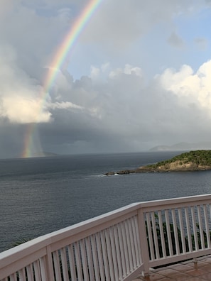 View from deck. Rain storm passes Lee Point of Thatch Cay.