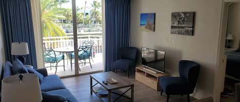 Living room with balcony overlooking pool