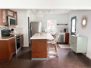 A view of the kitchen and main entrance door