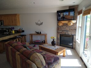 Living Room w/satellite TV and door to deck.