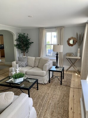 Beach inspired casual living room. Down linen couches and bright sun filled room