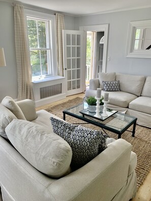 Living room opens to the dining room and kitchen. 