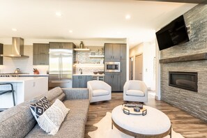 Luxury living area with flatscreen TV and gas fireplace.