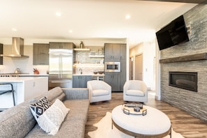 Luxury living area with flatscreen TV and gas fireplace.