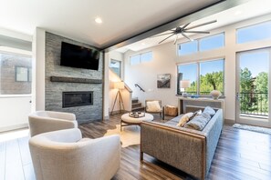 Luxury living area with flatscreen TV and gas fireplace.