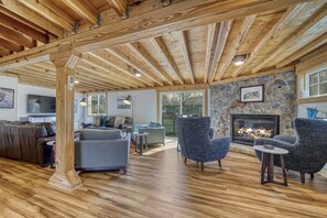 Expansive living room with multiple seating areas, and easy to move furniture
