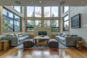 Main Living area with vaulted ceilings and gas fireplace, electronic blinds