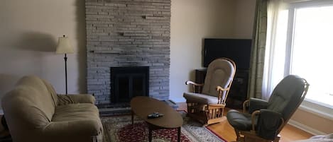 Living room with non-working fireplace.