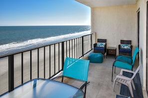 The furnished oceanfront balcony is accessible from the living area. 