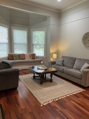 Living room with plenty of seating and lighting.