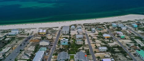 Aerial view of the beautiful waters of Mexico Beach with the red star indicating the location of this property.